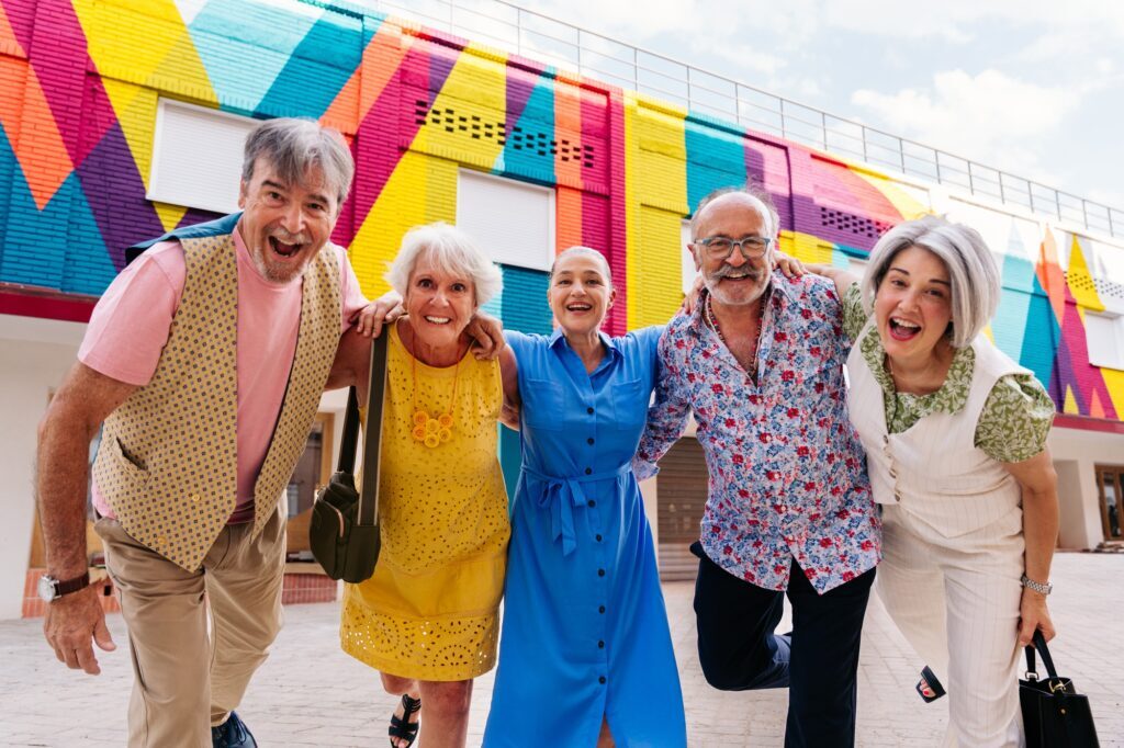 Group of senior friends meeting outddors in the city and having fun