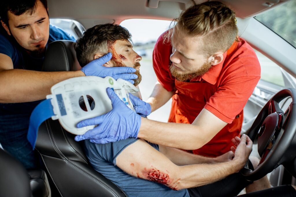 Medics providing emergency medical assistance after the road accident