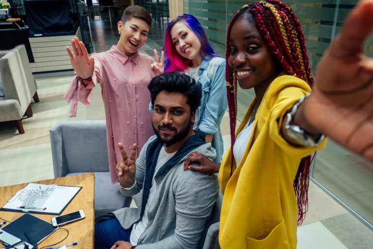 multiracial business group working taking selfie portrait on camera smartphone at modern office