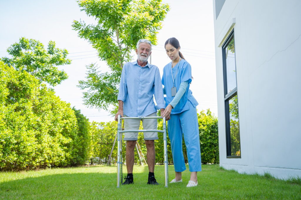 Nurse helping elderly to learn to walk,Medical concept.